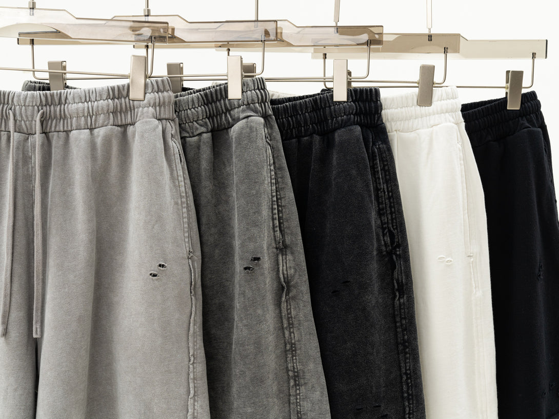 Hanging display of all color cotton shorts - artisan dye-wash distressed collection for wholesale suppliers