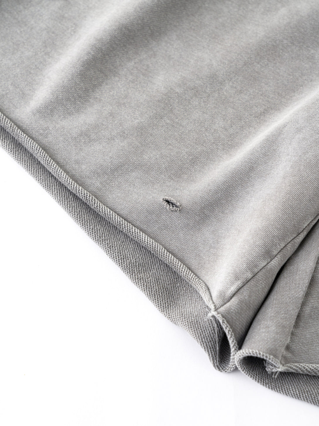 Hem stitching detail on Gray shorts - double-reinforced distressed edge for durability