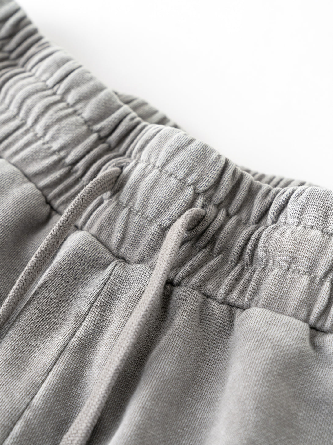 Gray cotton shorts waistband close-up - reinforced elastic with artisan dye-wash finish