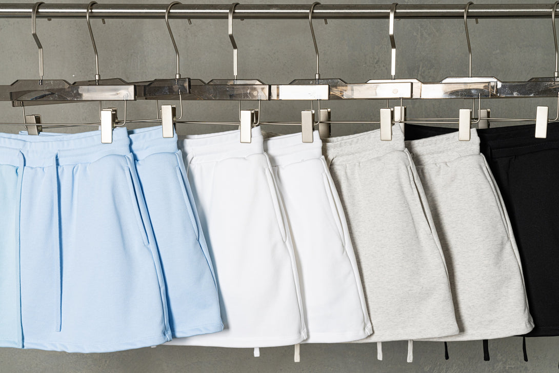 Hanging display of all color cotton skirts - gym-to-street athleisure collection for wholesale suppliers