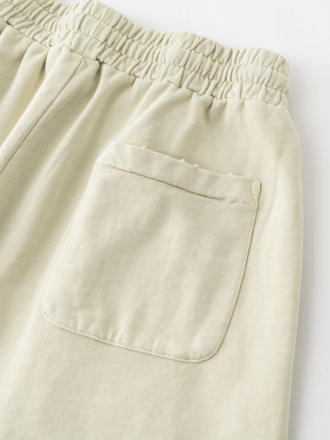 Back pocket reinforcement on Khaki athletic shorts - heavy-duty cotton for gym use
