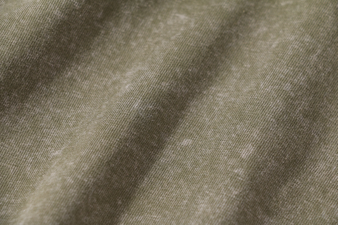 Texture and weave detail of the 100% cotton fabric on this vintage long-sleeved T-shirt.
