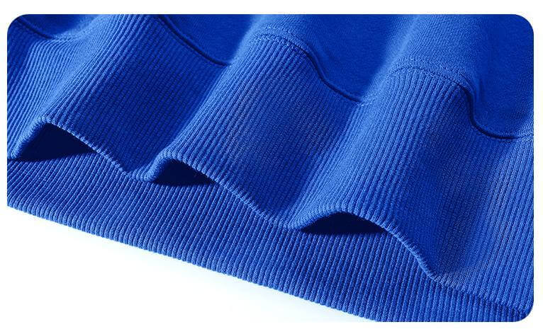 Close-up of ribbed cuffs and hem of a blue Blank Hoodie Wholesale made from 300gsm cotton fabric.
