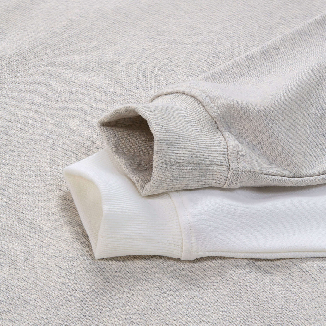 Blank Zip Hoodie sleeves in light gray and white cotton fabric, showcasing softness and quality construction.