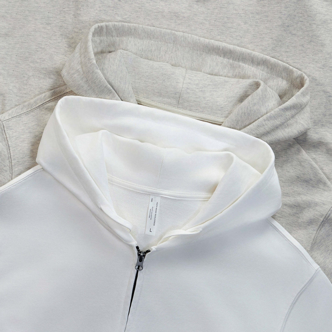Blank Zip Hoodie in white and gray, showcasing premium construction and unisex design for versatile styling.