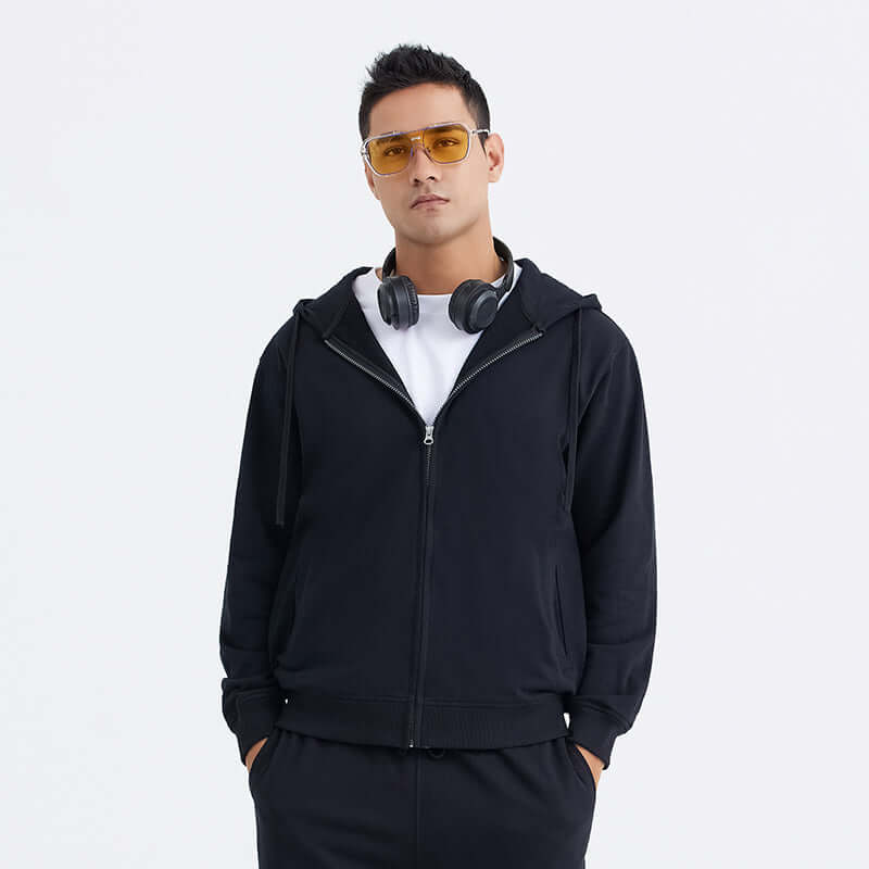 Blank Zip Hoodie worn by a model, featuring a full zip design, black color, and casual streetwear style.