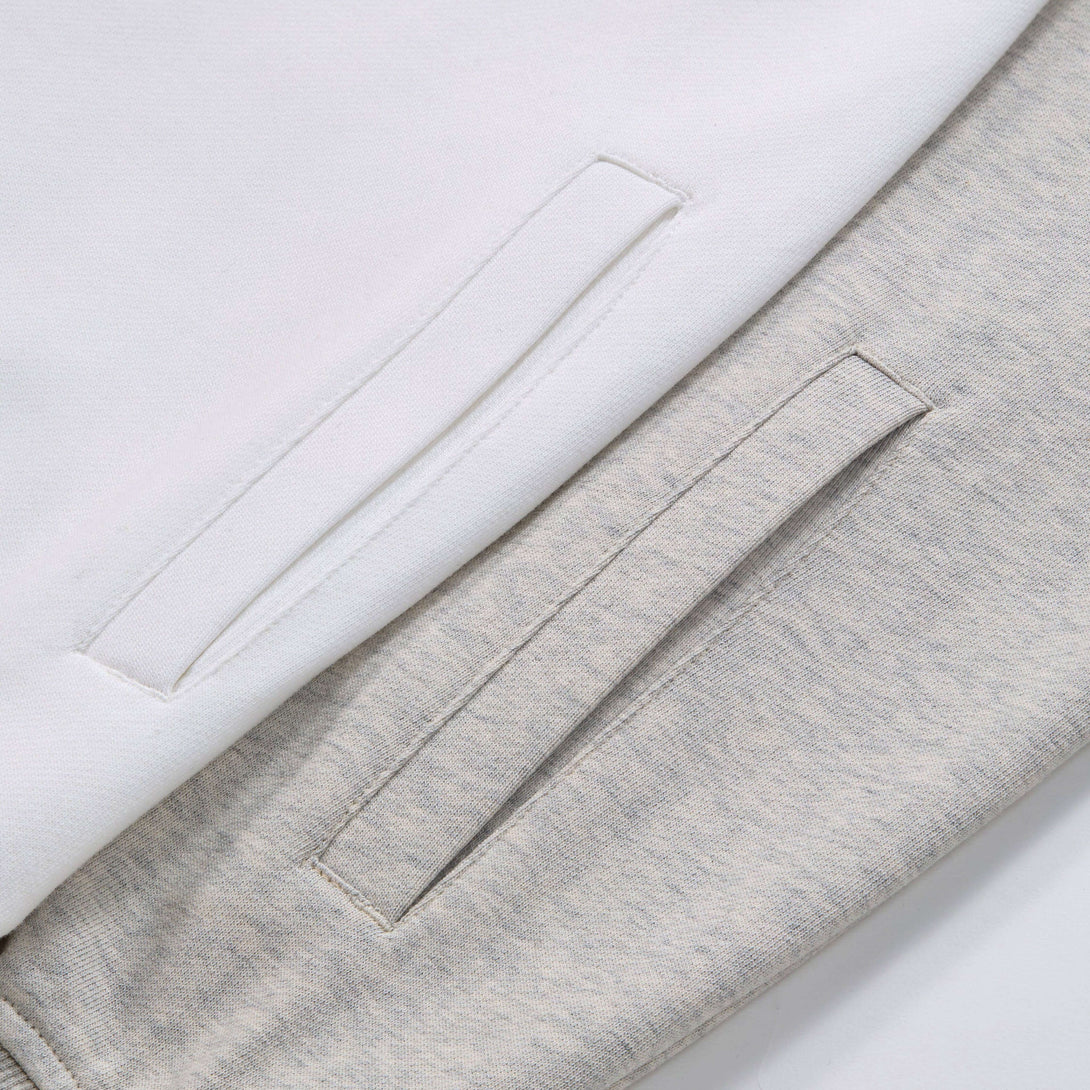 Detail of pockets on Blank Zip Hoodie, showcasing white and grey fabric textures.