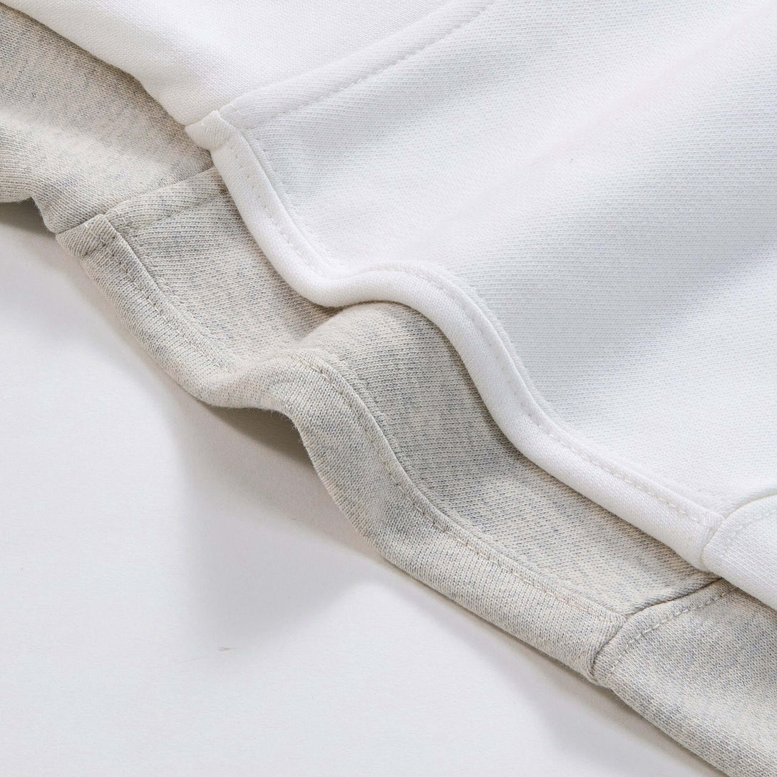 Blank Zip Hoodie fabric detail showing 100% cotton texture in white and beige colors.
