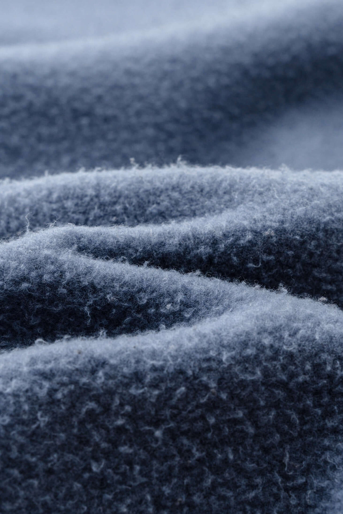 Close-up detail of premium 360gsm brushed fleece fabric used in the Spray Effect Quarter Zip pullover.