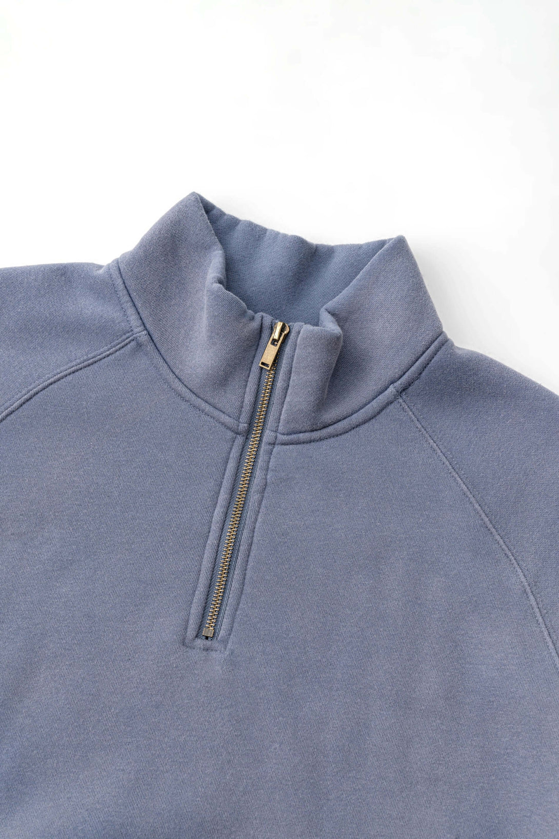 Spray Effect Quarter Zip pullover in soft blue with stand-up collar and quarter zip design, perfect for urban streetwear.