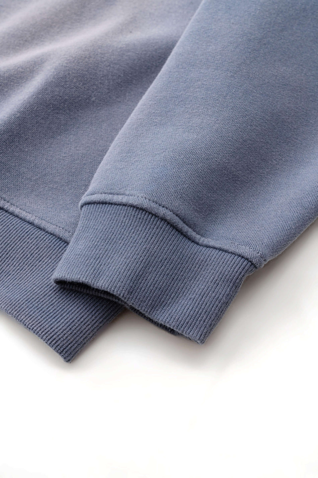 Close-up of cuffs and hem of Spray Effect Quarter Zip, showcasing premium 360g fleece texture and stitching.