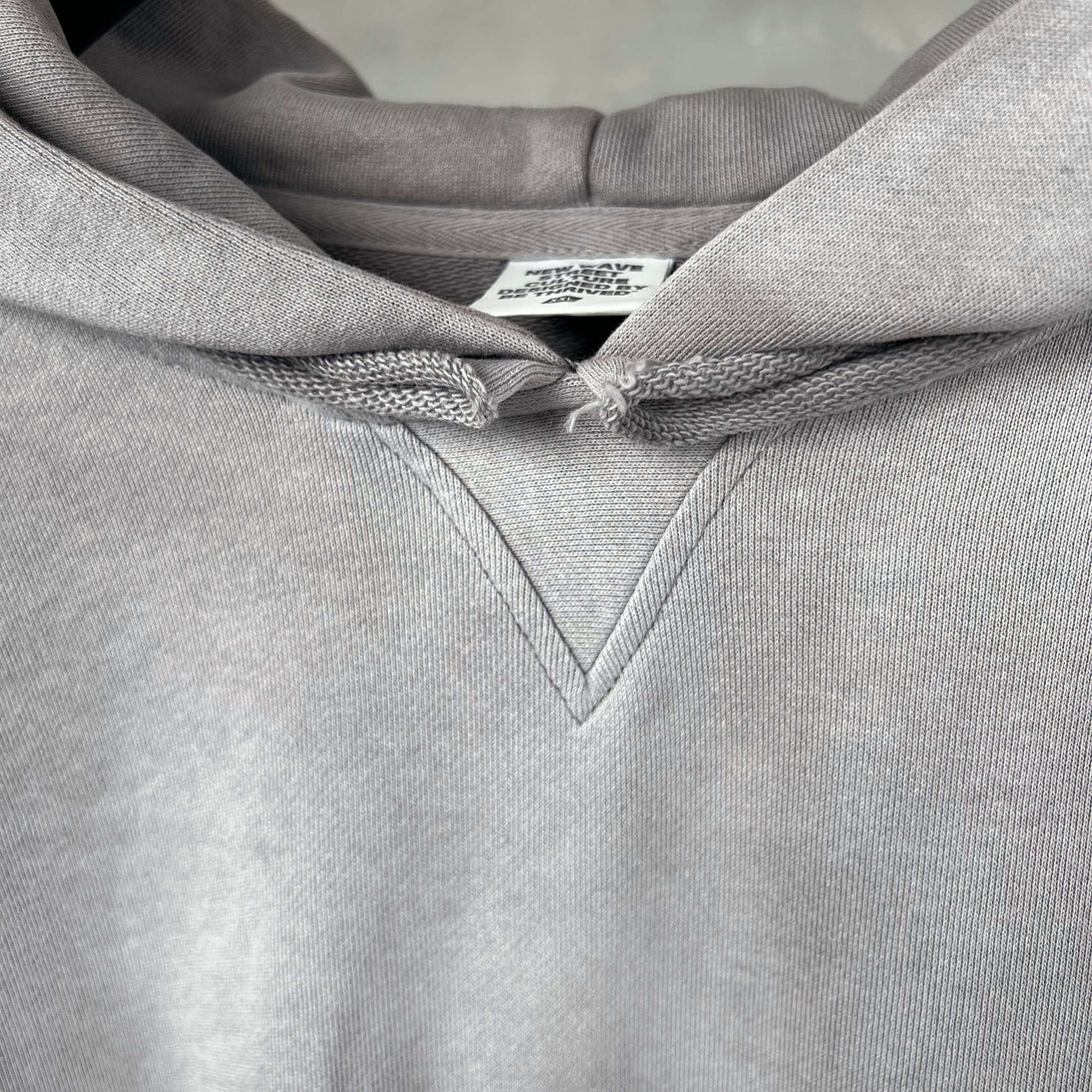 Close-up of Vintage Spray Paint Hoodie showcasing the hood and neckline details.