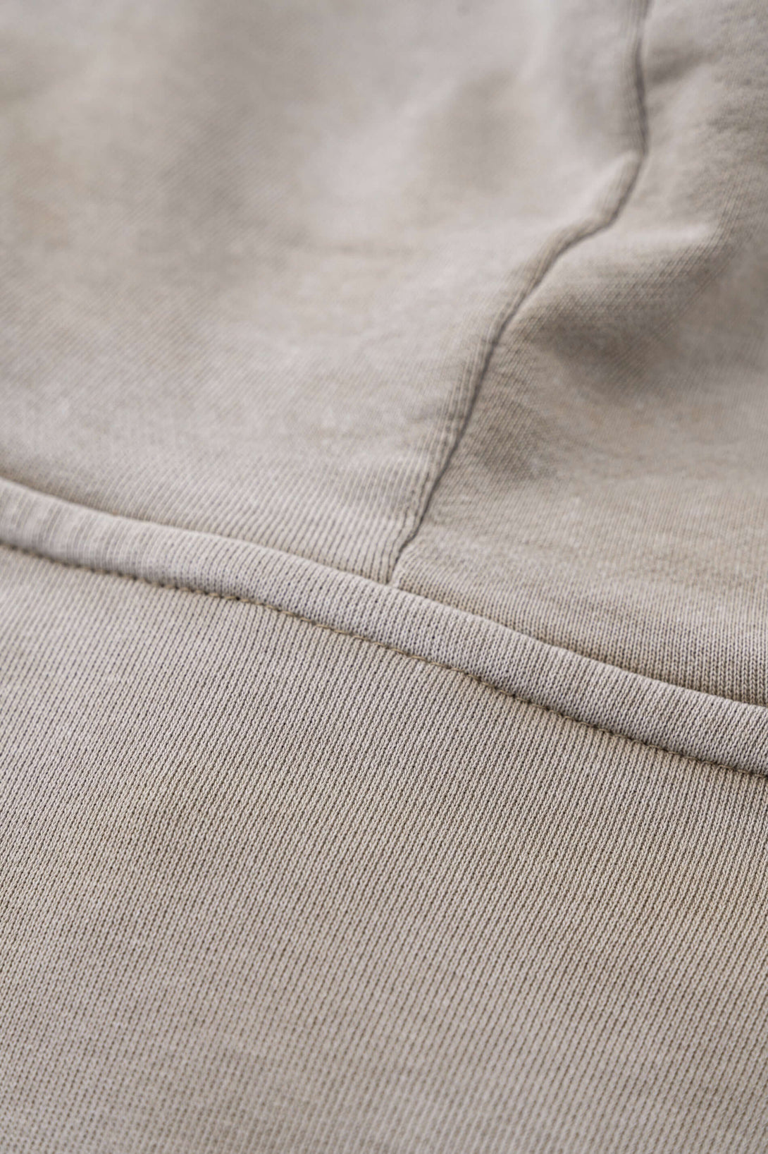 Close-up detail of Vintage Batik Hoodie fabric showcasing distressed texture and raw edge design.