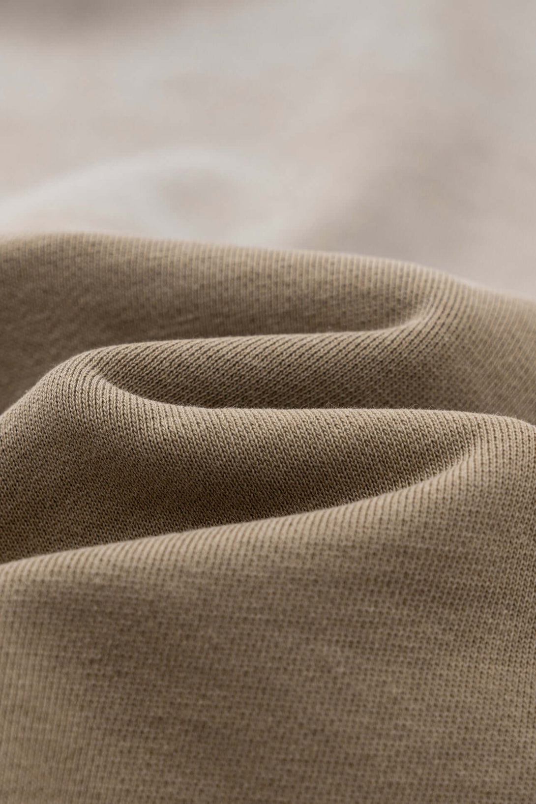 Close-up of soft, textured beige fabric showcasing the material of the Vintage Batik Hoodie.