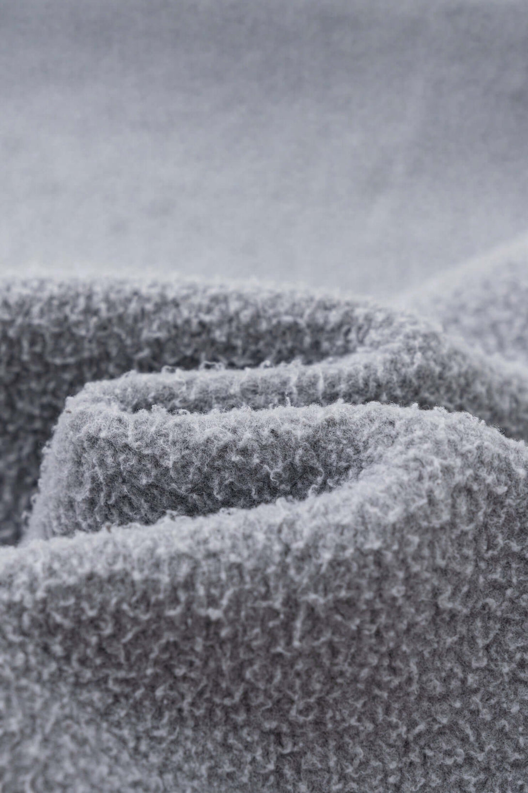 Close-up of soft grey brushed fleece fabric for Double Zip Washed Hoodie, showcasing texture and warmth.