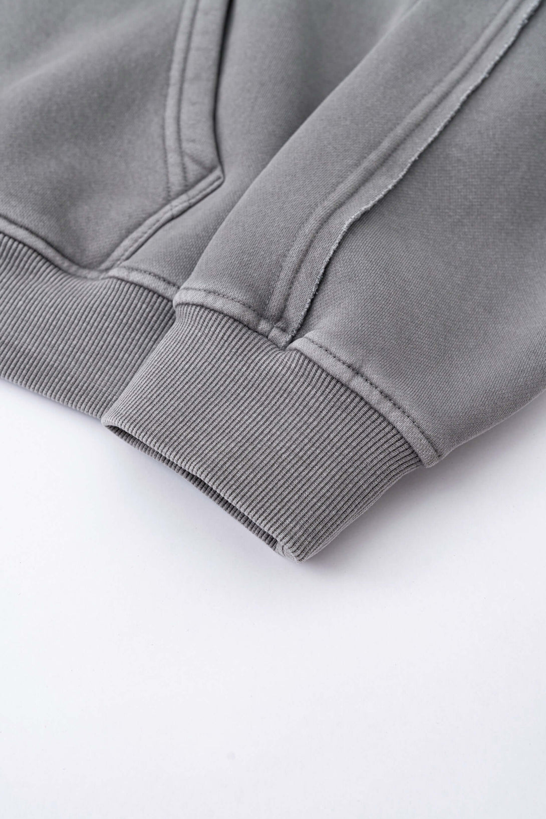 Detail of the cuff on a Double Zip Washed Hoodie, showcasing the soft brushed fleece material and ribbed hem.
