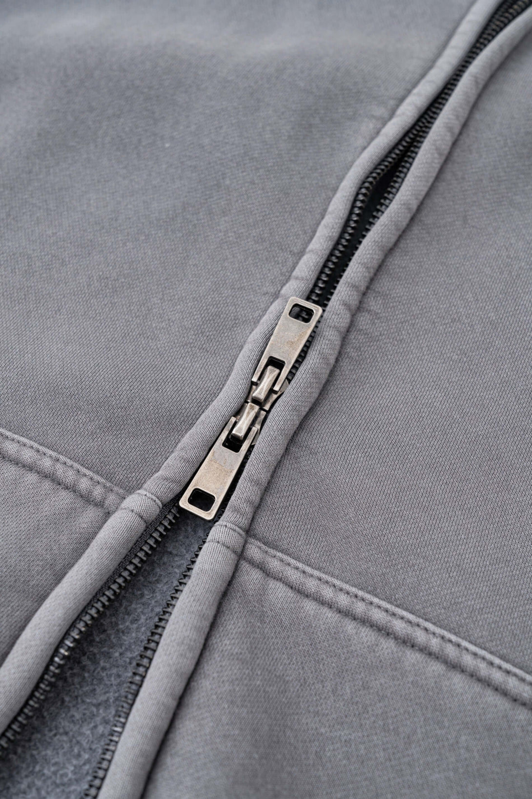 Close-up of the zipper detail on the Double Zip Washed Hoodie, showcasing its premium urban streetwear design.