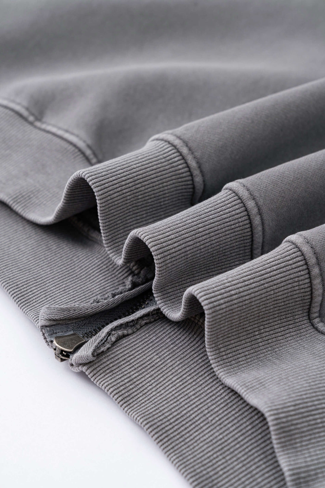 Double Zip Washed Hoodie featuring detailed stitching and zippered cuffs in a soft grey fleece fabric.