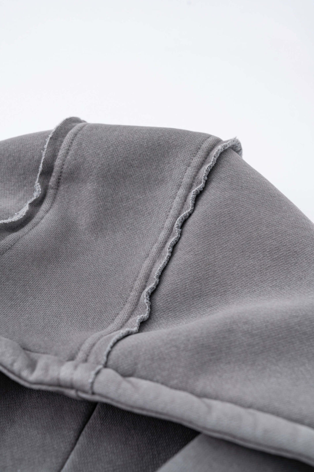 Detail of the Double Zip Washed Hoodie showcasing the premium fleece fabric and urban design.