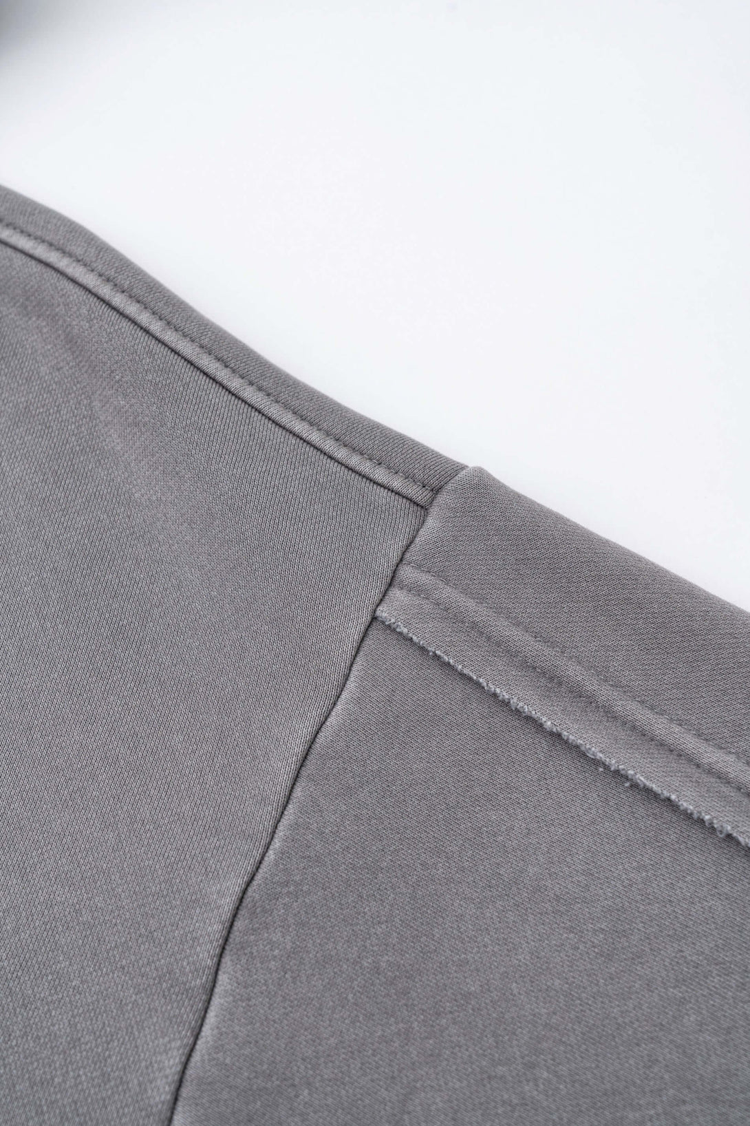 Close-up view of the seam detail on the Double Zip Washed Hoodie, showcasing premium fabric quality and craftsmanship.