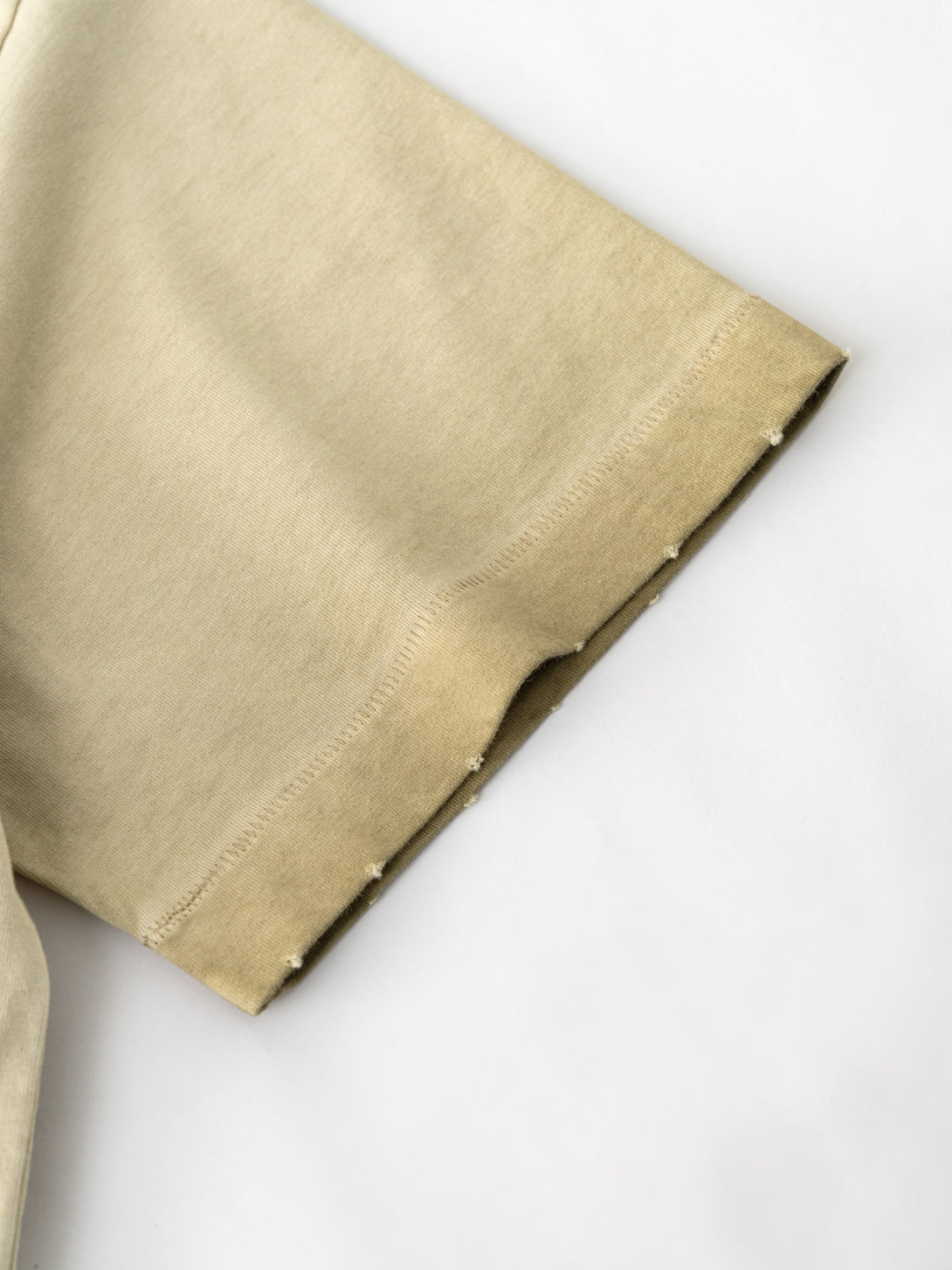 Khaki raw-edge sleeve print close-up - Hand-brushed pigment texture wholesale blank