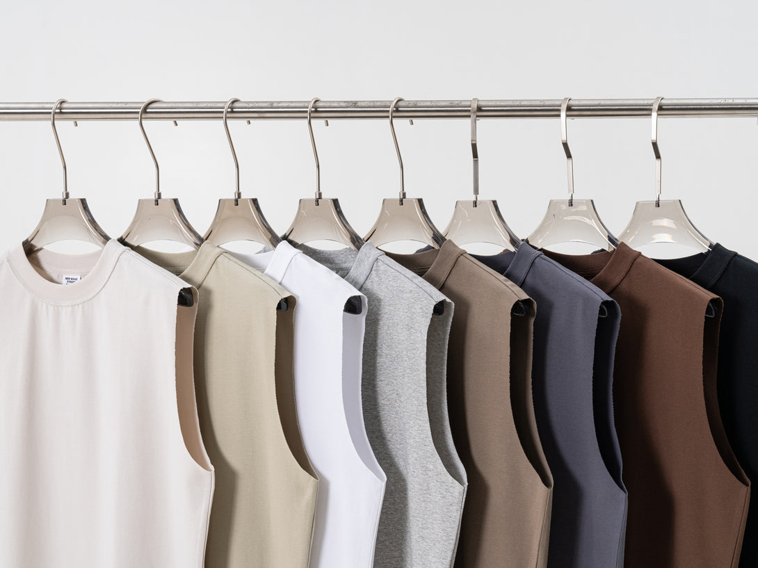 Hanging display of all 8 color oversized tanks - sustainable streetwear collection for wholesale bulk orders