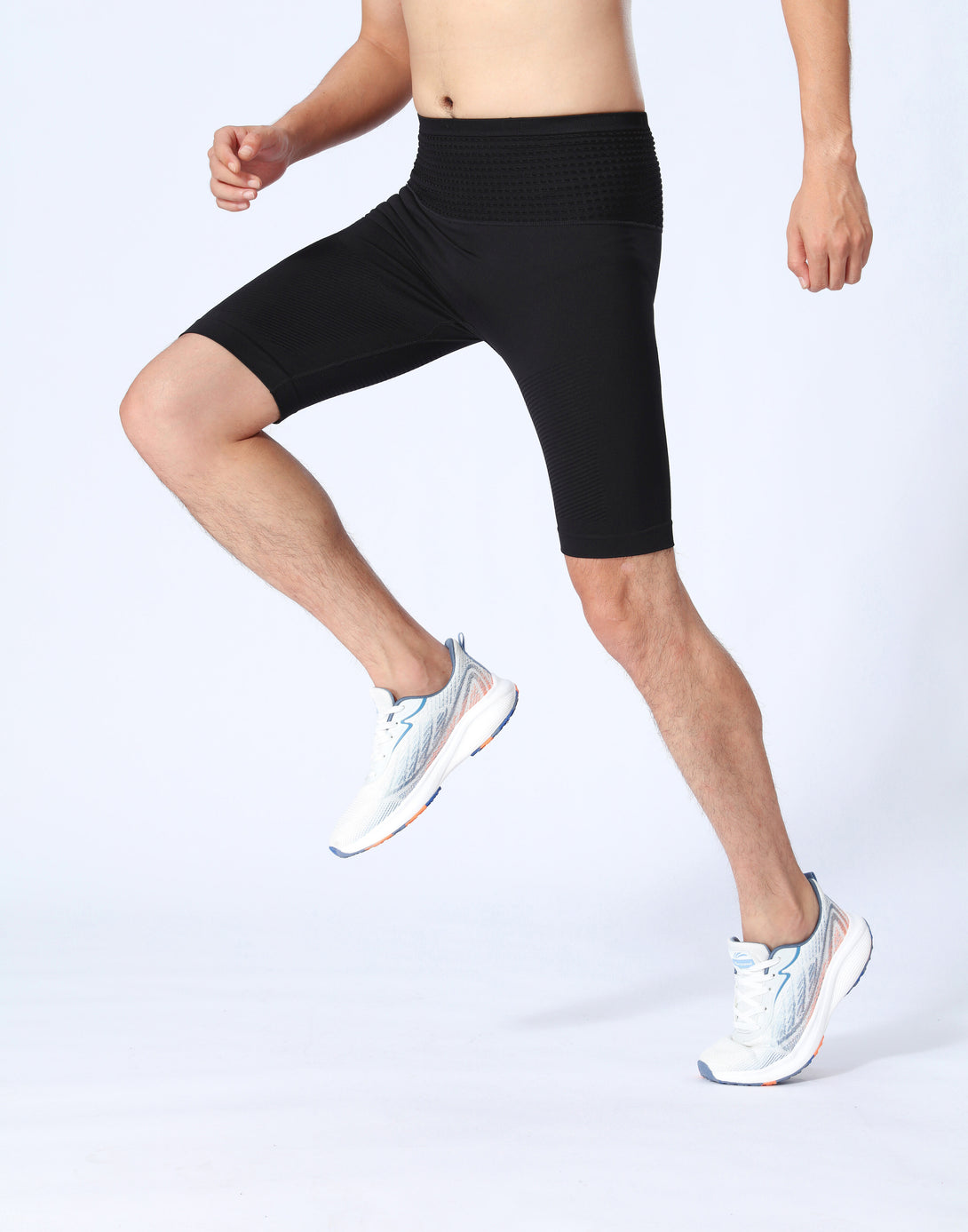 Sports action pose in black compression athletic shorts