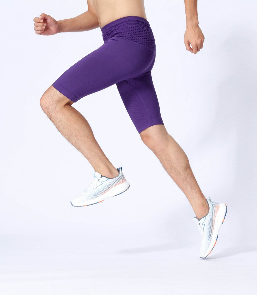 Athlete in dynamic pose with purple compression shorts