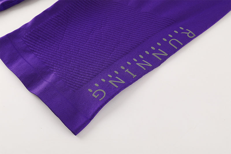 Hem construction detail on purple compression shorts