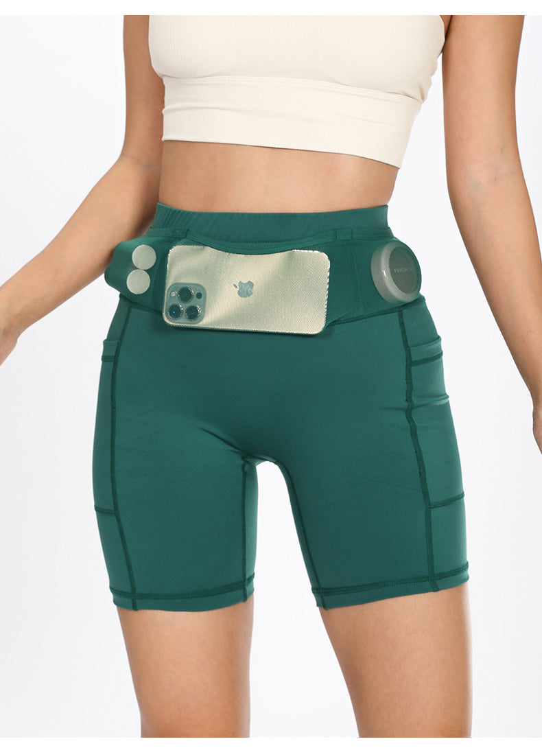 Female model wearing green compression shorts front