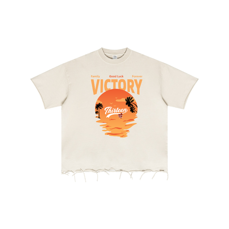 Graphic print detail on Apricot pigment-dyed oversized tee, raw-edge texture for quality control.
