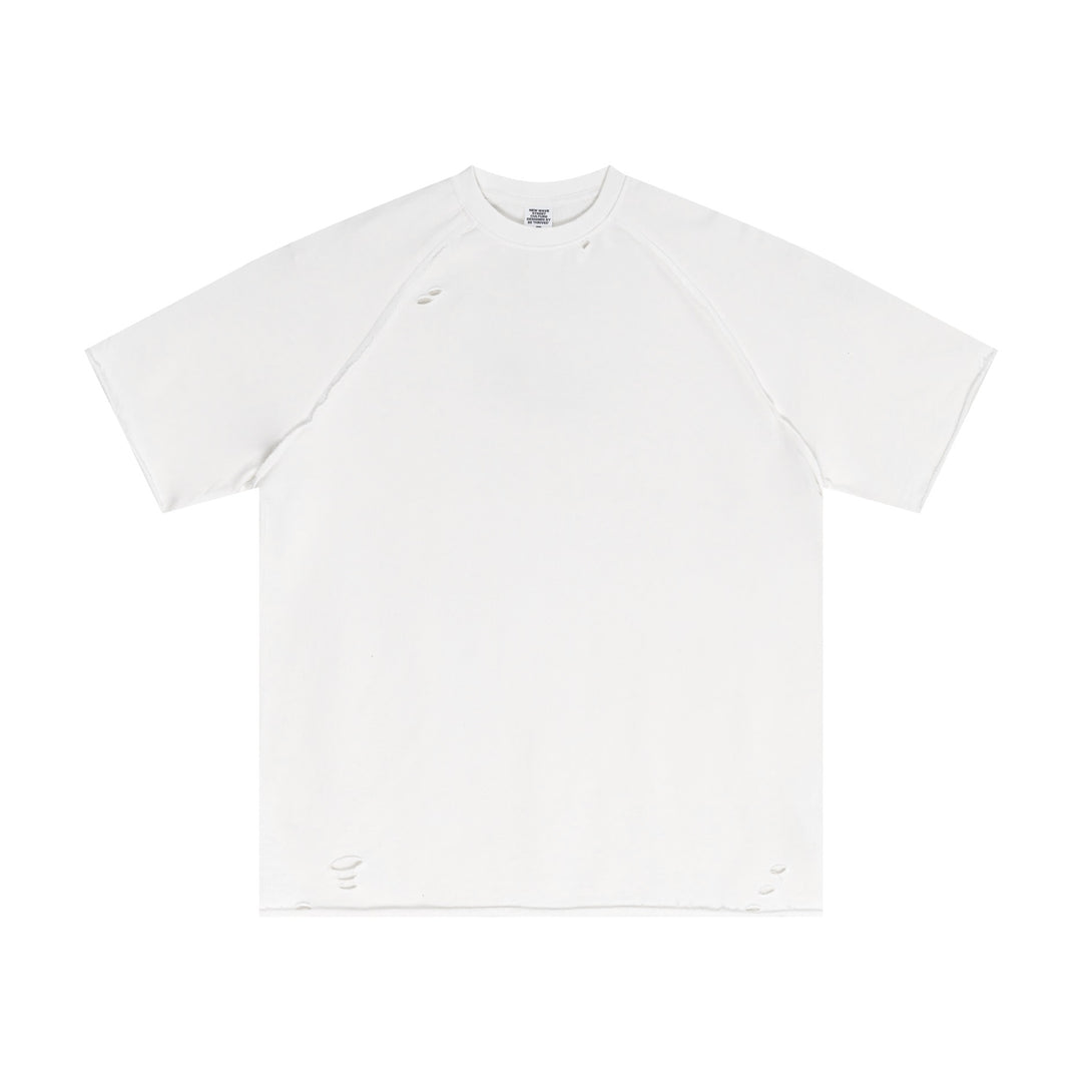 Off-White oversized cotton tee with artisan snow-wash technique and raw-edge trim, front view. Vintage streetwear essential for wholesale bulk orders.
