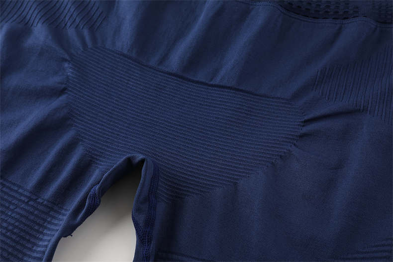 Hip panel construction detail on blue compression pants