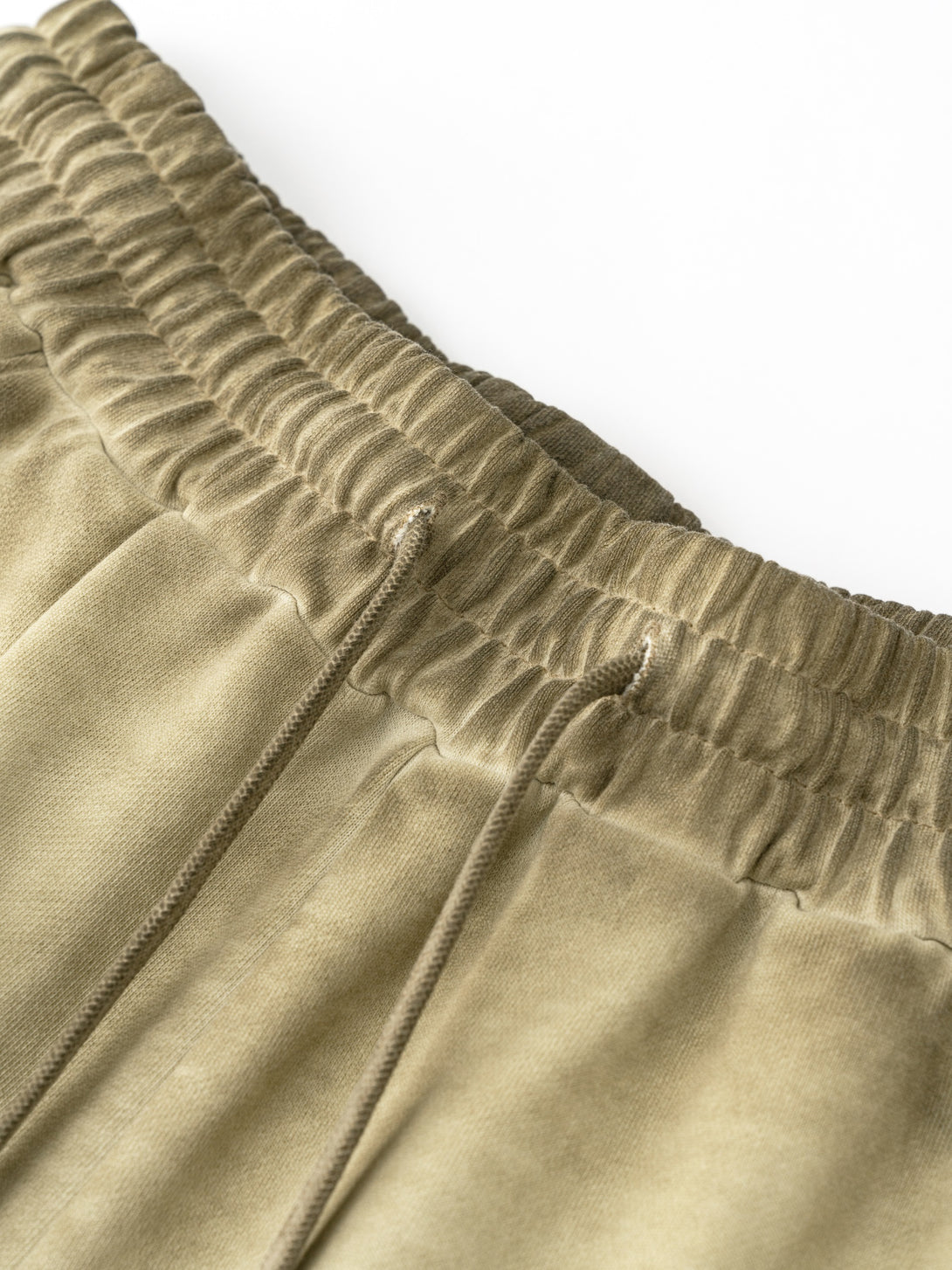 Khaki cotton shorts waistband close-up - heavy vintage wash distressed detail