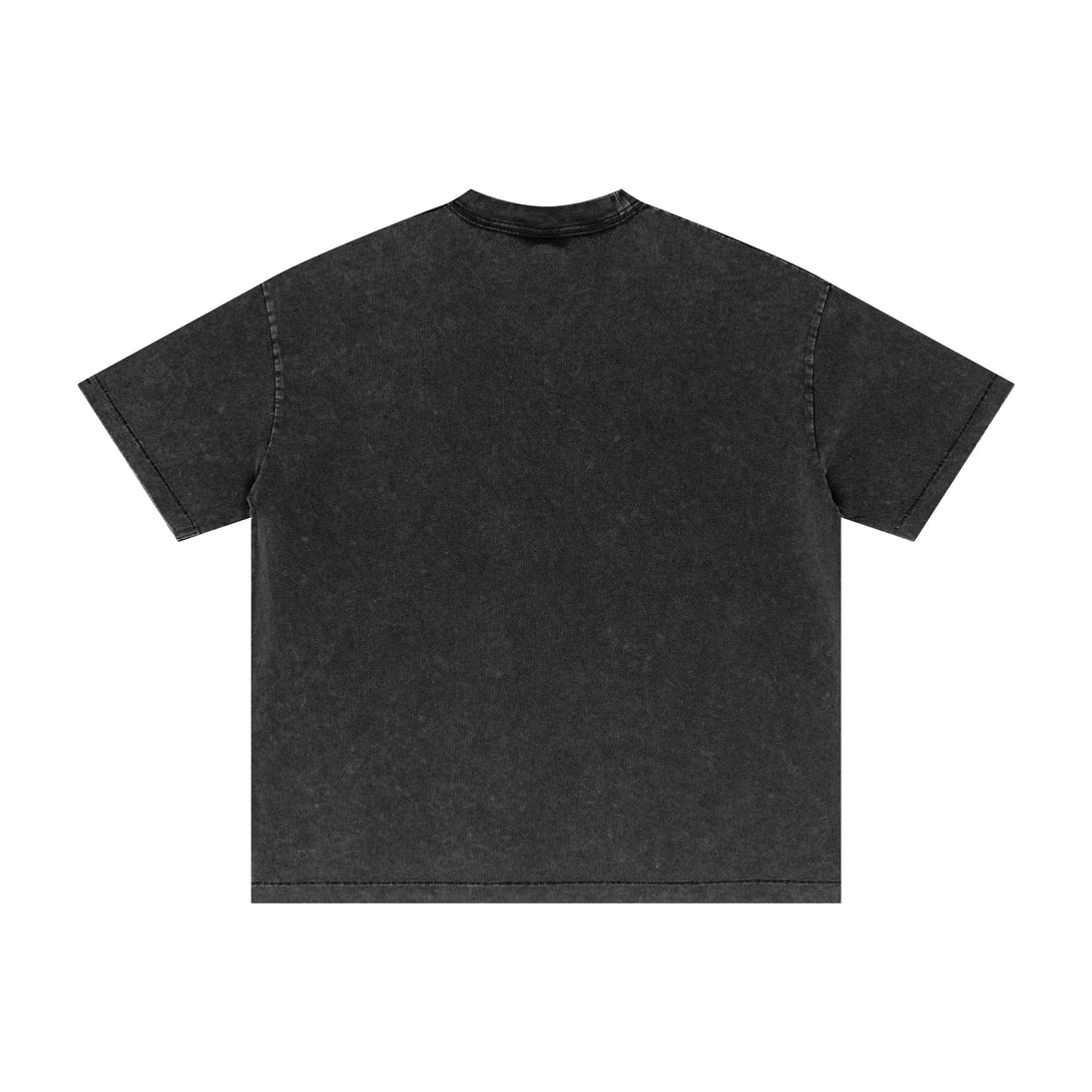 Back view of black oversized cotton tee with distressed details and pigment-dyed finish. SS25 vintage wash streetwear for wholesale.