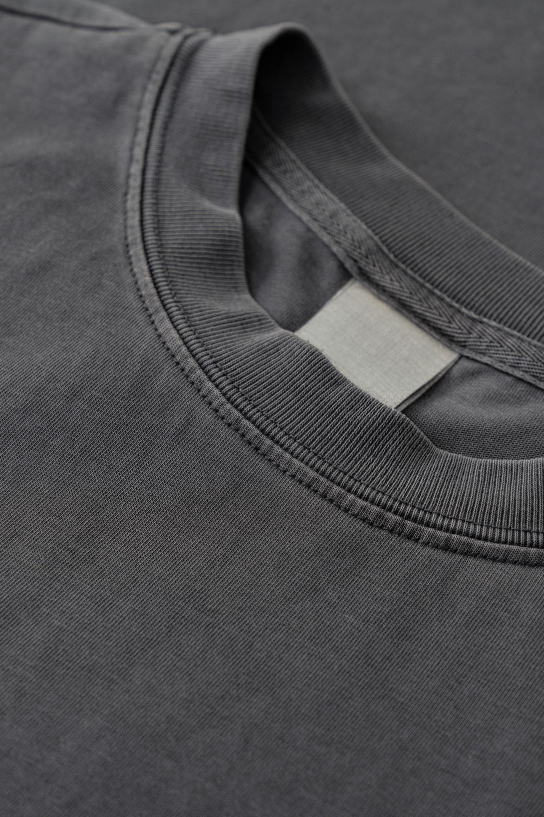 Reinforced ribbed collar construction detail on Dark Gray oversized cotton women's tee.