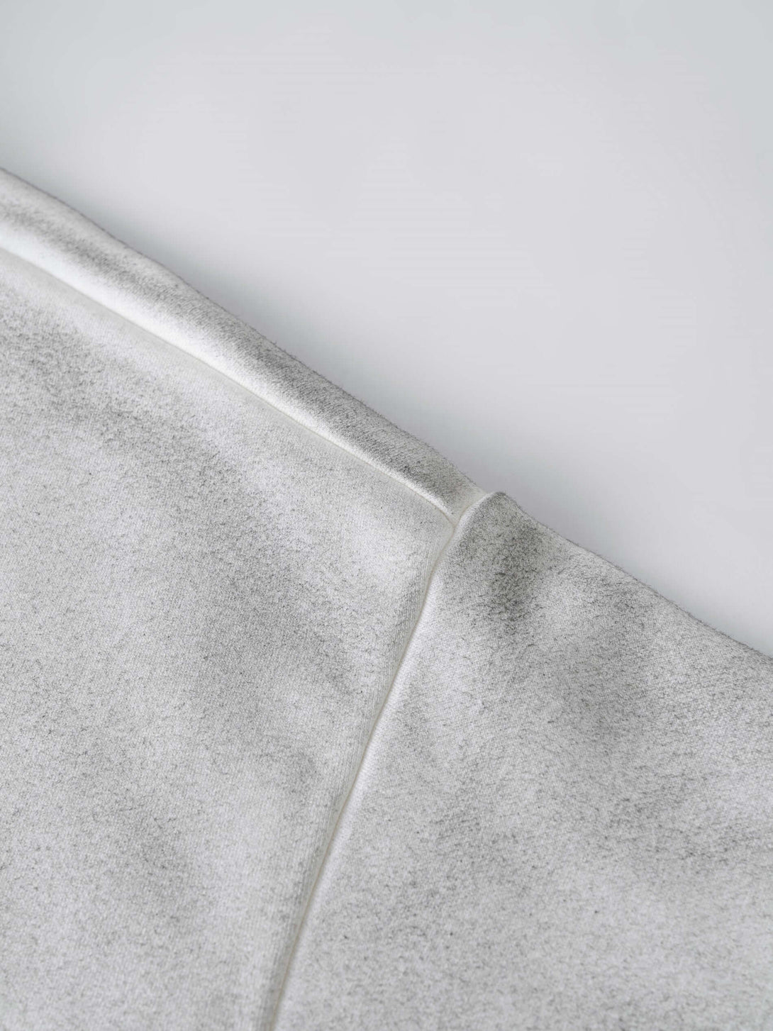 Close-up of the fabric detail on men's 340g grey camo weighted hoodie - spray dye pullover showcasing quality design.