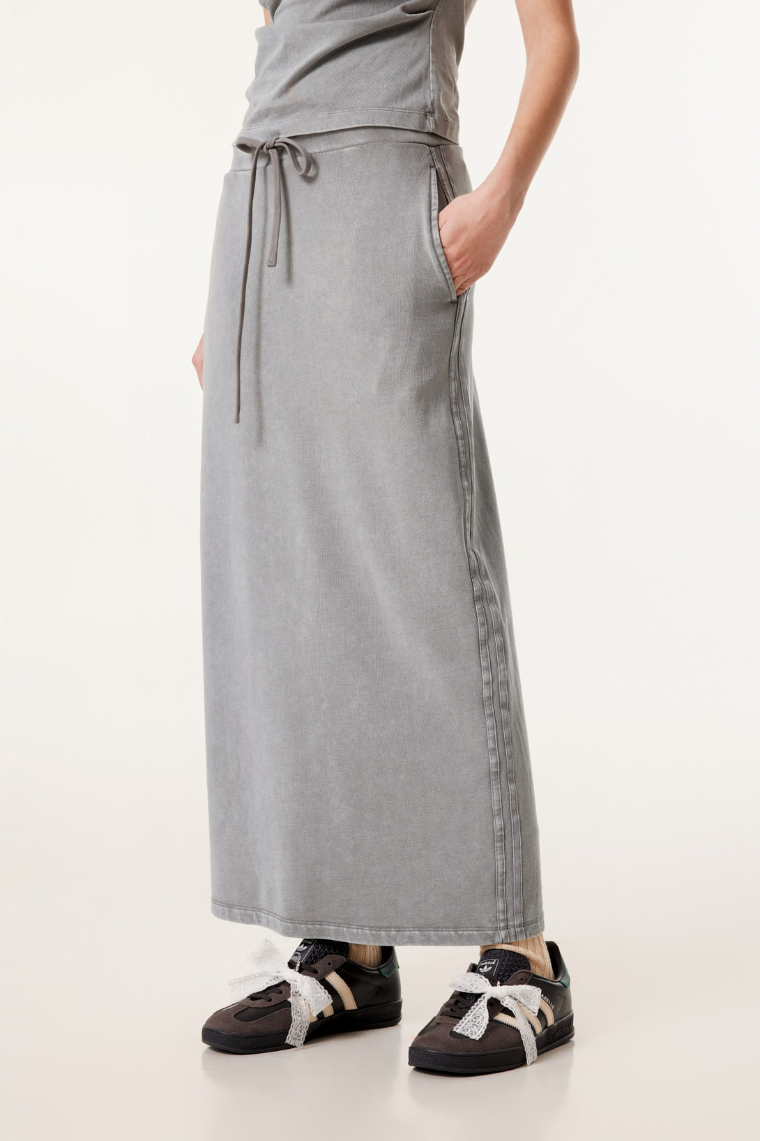 Model wearing front view of heavy wash high-rise skirt