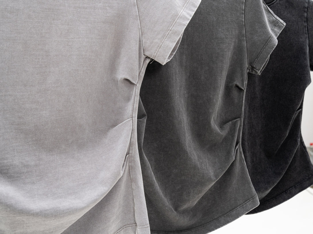 Heavy wash women's t-shirt on hanger showing waist gather feature