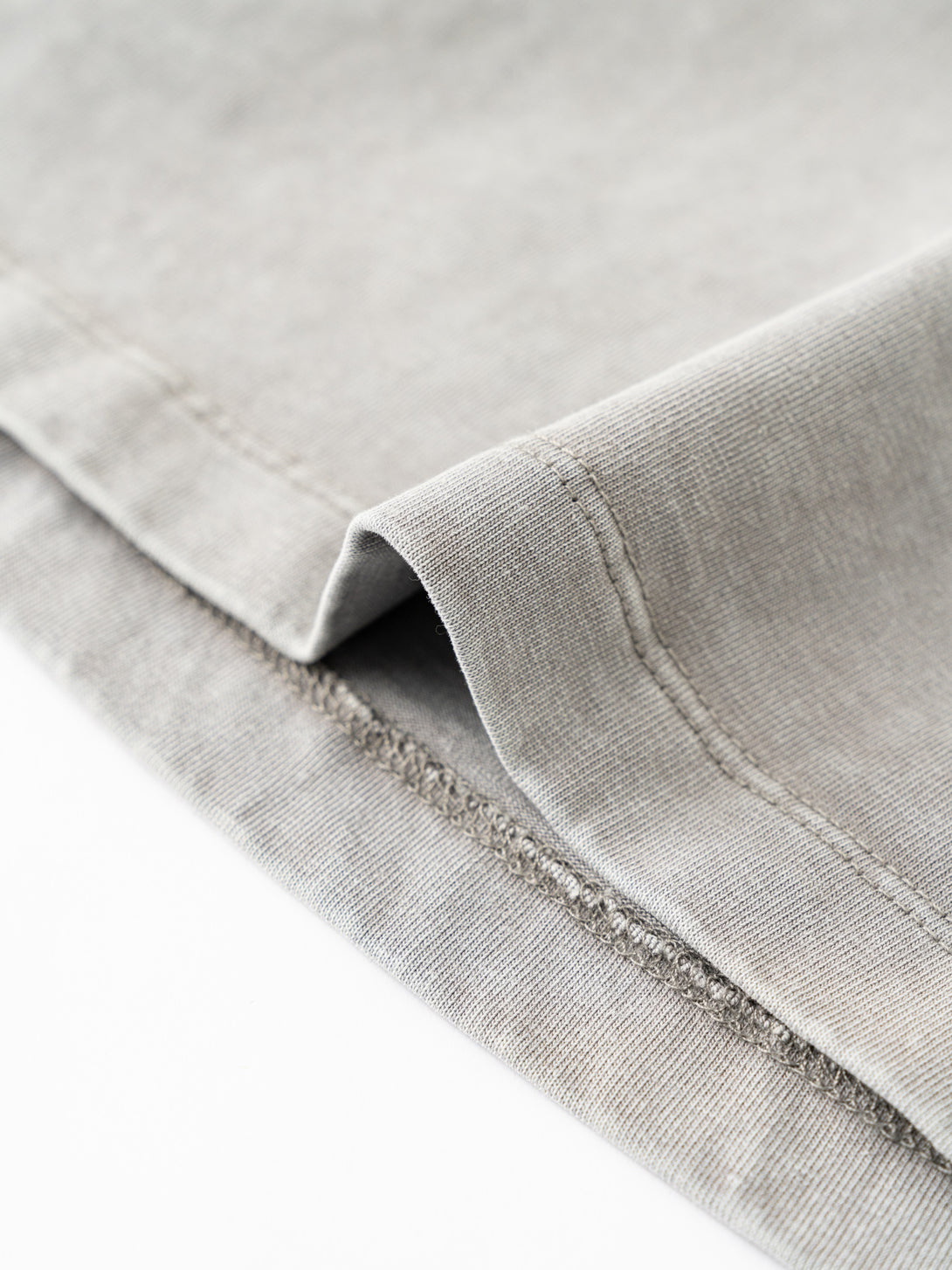 Double-needle hem detail at bottom of heavy wash women's t-shirt
