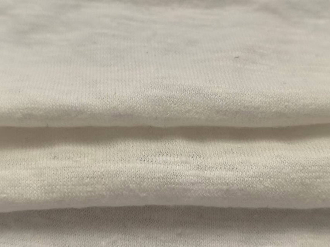 Close-up texture of White hemp-organic cotton fabric (55/45 composition, 210GSM), hypoallergenic textile inspection for bulk production QC.
