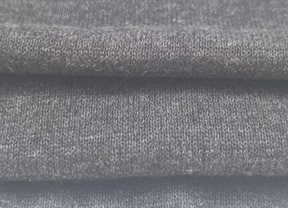 Close-up texture of Charcoal Ash hemp-blend fabric (55/25/20 composition, 230GSM), showcasing sustainable textile quality for eco apparel manufacturing and bulk orders.