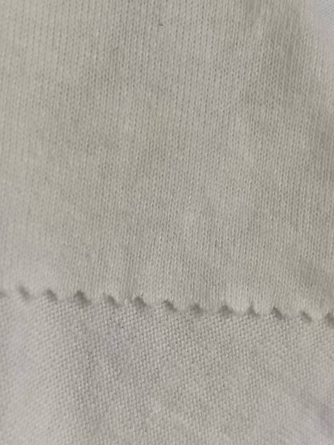 Detailed hemp-tencel fabric weave inspection (270GSM), sustainable textile quality for bulk apparel production.