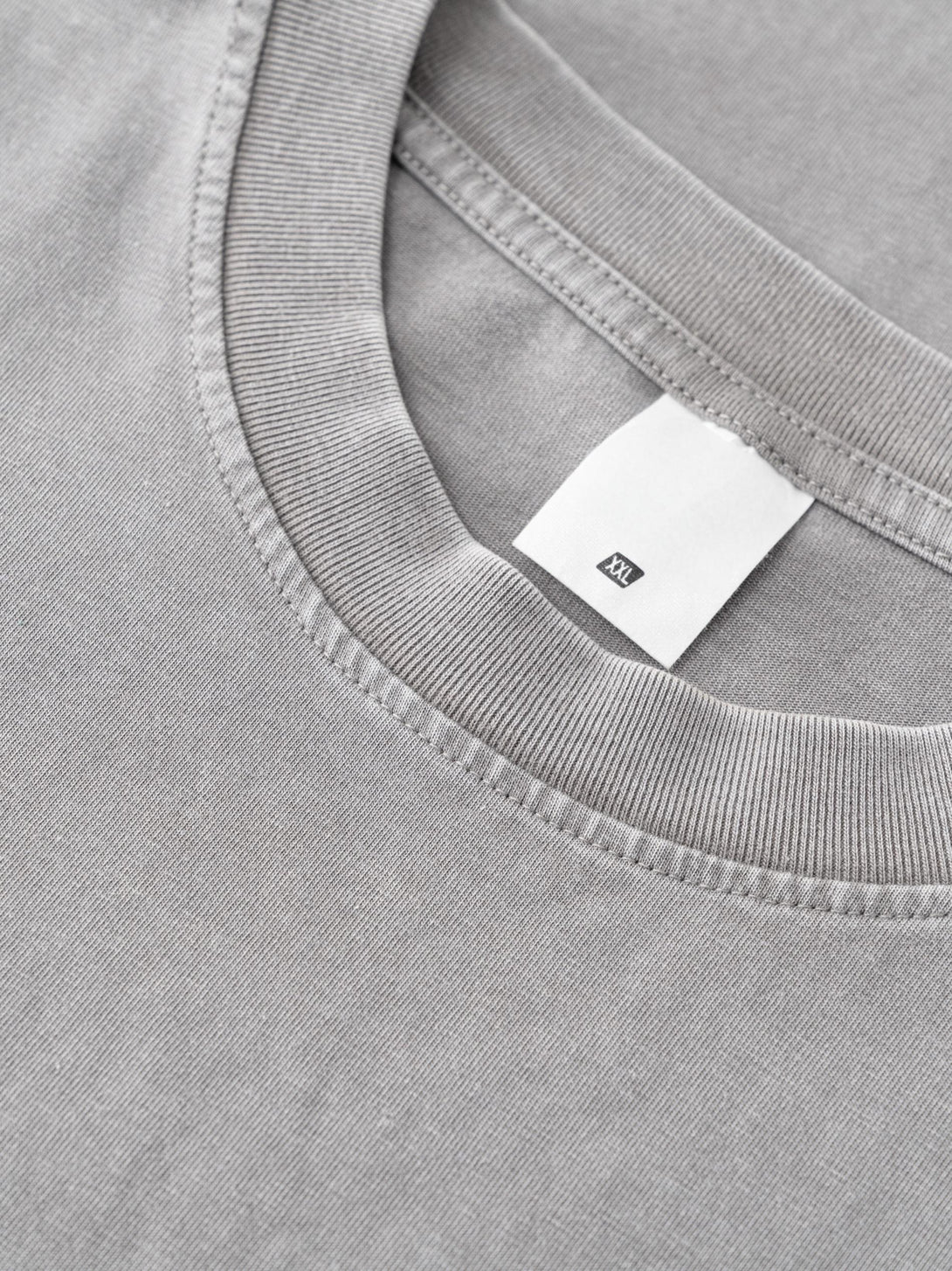 Ribbed collar construction detail on Light Gray oversized cotton tee.