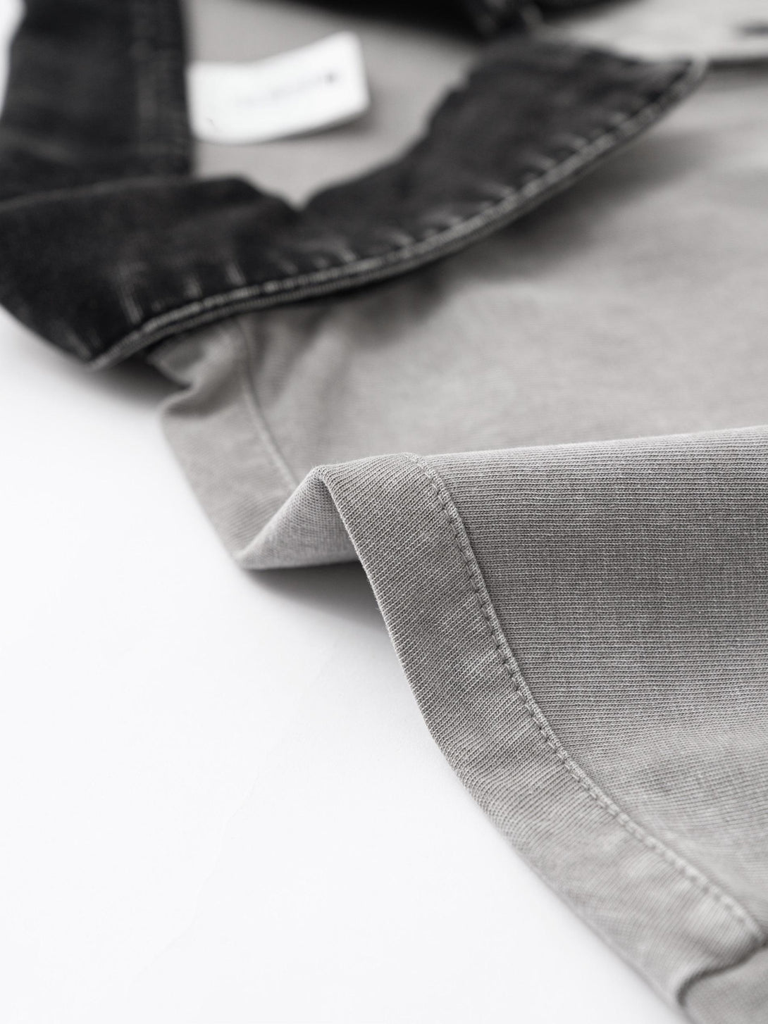Ribbed collar stitching on Light Gray vintage wash polo, durability feature for bulk production.
