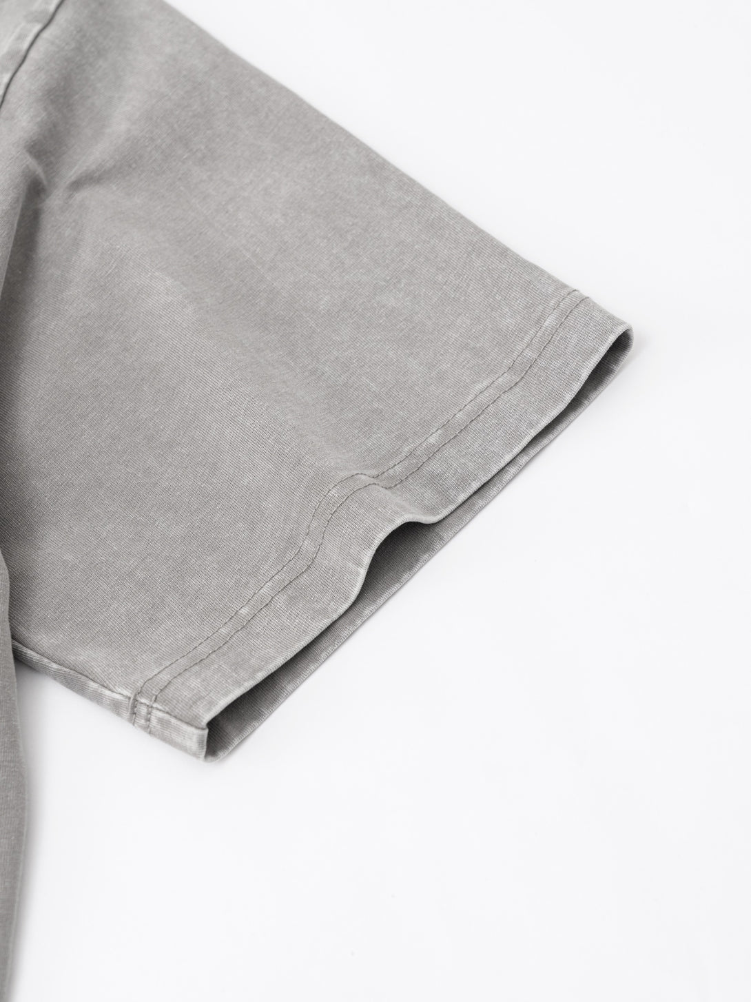 Sleeve hem with distressed detailing on Light Gray oversized polo, streetwear finishing sample.