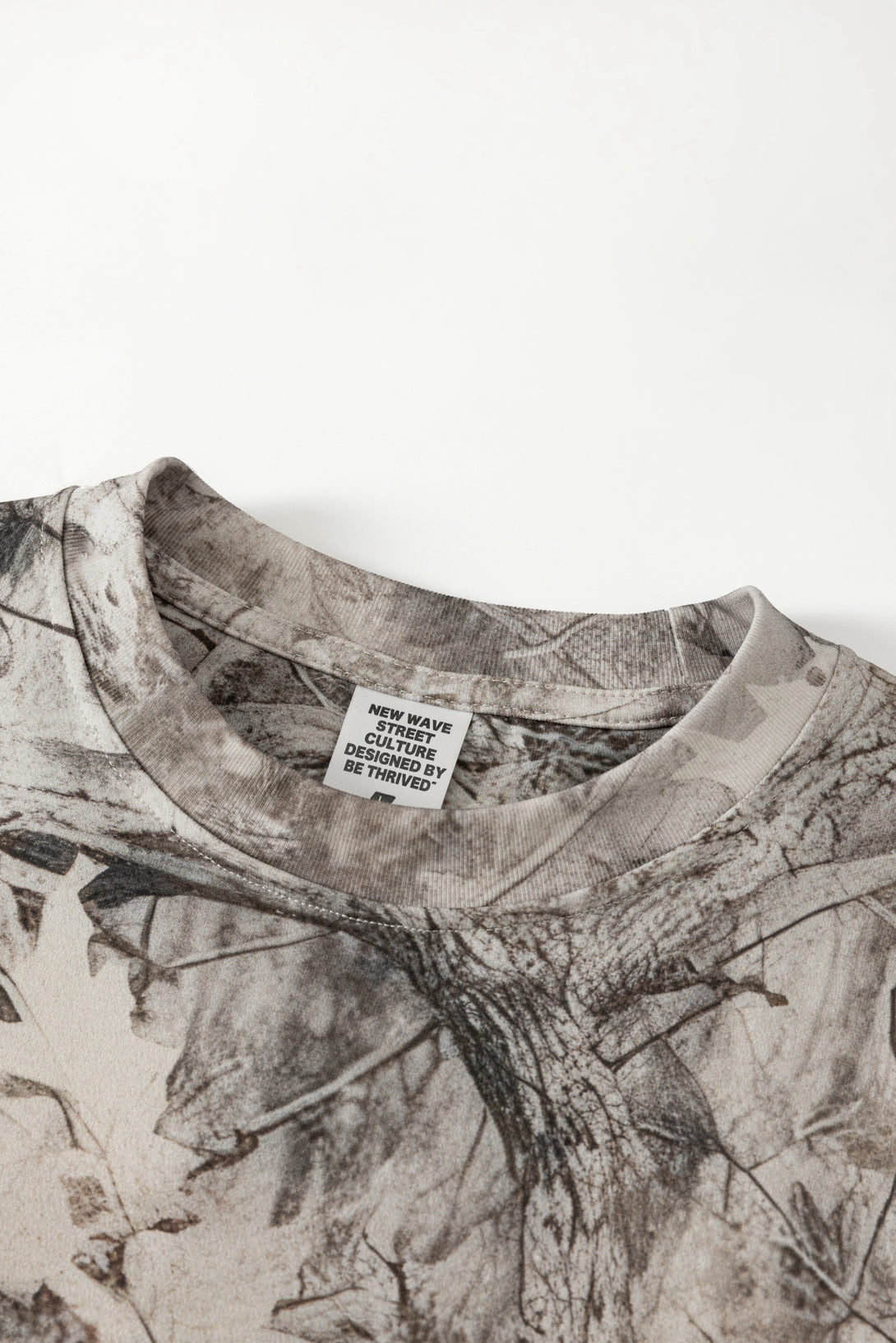 Men's 240g Camouflage All Over Print T-Shirt close-up showing fabric and label details.
