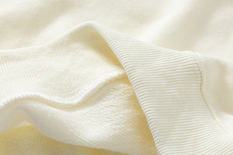 Close-up showing the precise hem stitching on the Organic Cotton Sweatshirt.