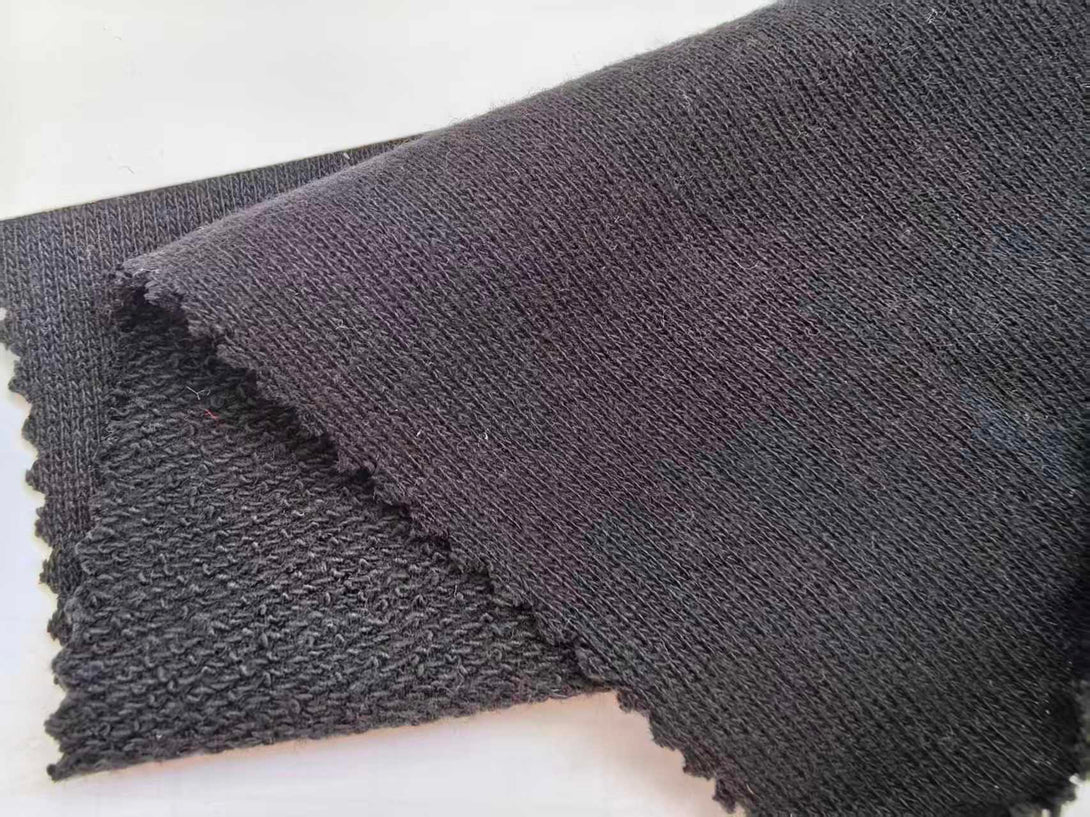 Black fabric swatch showing the true color of the Organic Cotton Sweatshirt.