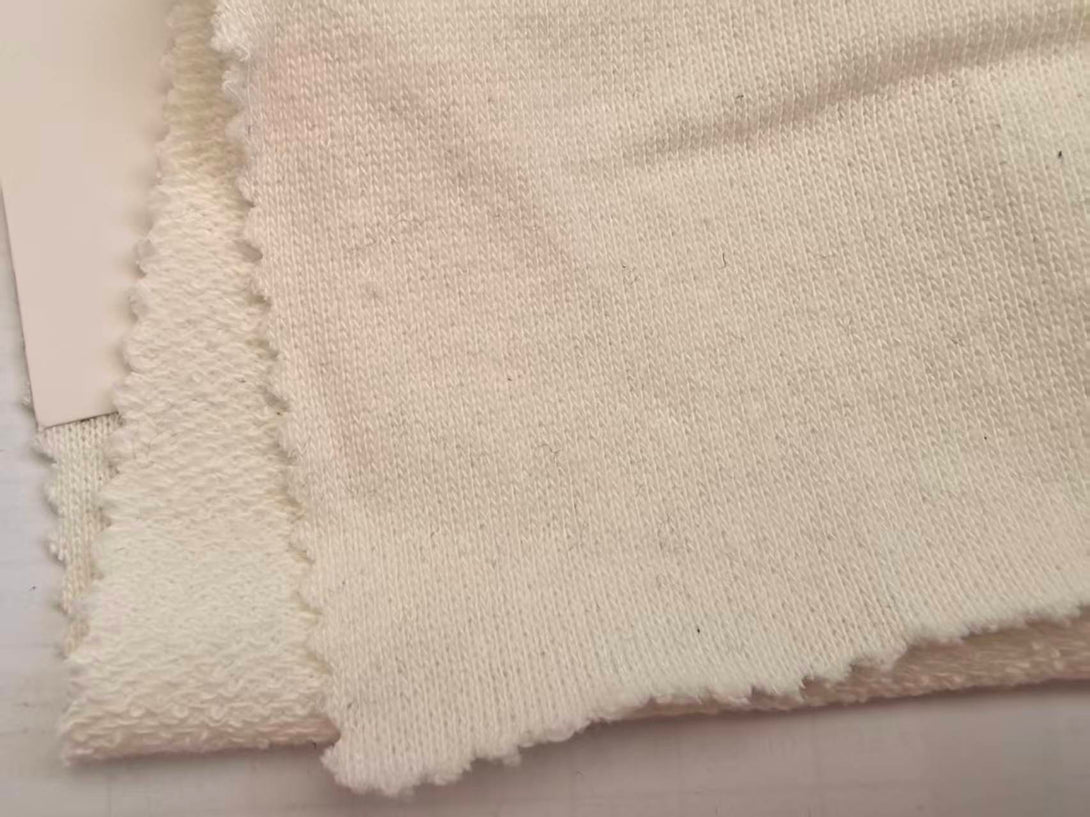 Natural undyed fabric swatch of the Organic Cotton Sweatshirt.